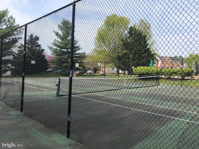 view of tennis court featuring fence