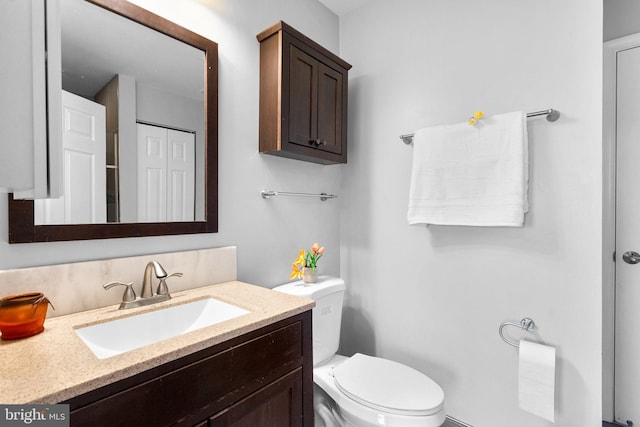 bathroom with toilet and vanity