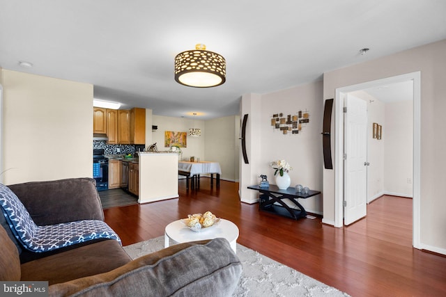 living room featuring baseboards and dark wood finished floors