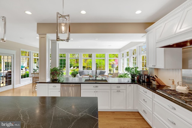 kitchen featuring a sink, white cabinetry, appliances with stainless steel finishes, and light wood-style flooring