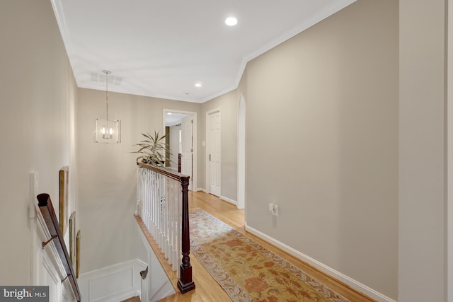 hallway featuring crown molding, baseboards, an upstairs landing, recessed lighting, and light wood-style flooring