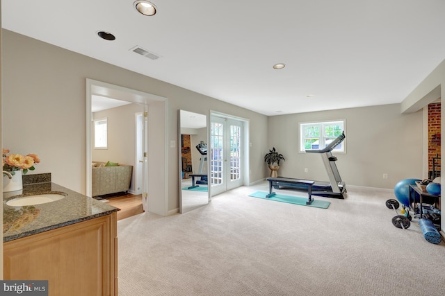 exercise room featuring french doors, visible vents, baseboards, light carpet, and recessed lighting