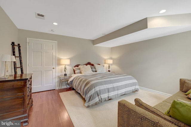 bedroom featuring recessed lighting, baseboards, visible vents, and wood finished floors