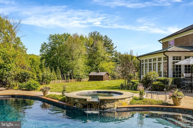 outdoor pool featuring an in ground hot tub, a storage shed, a lawn, an outdoor structure, and a patio