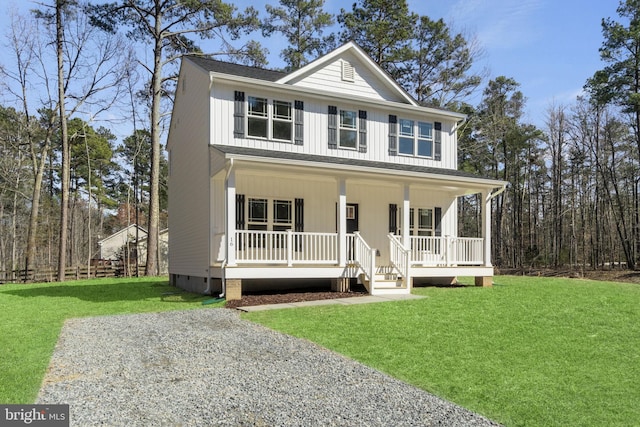 view of front of home with board and batten siding, a porch, a front yard, and crawl space