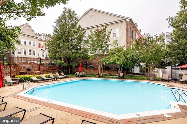 pool featuring a patio area and fence