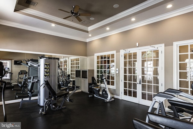 workout area with visible vents, a tray ceiling, french doors, crown molding, and ceiling fan