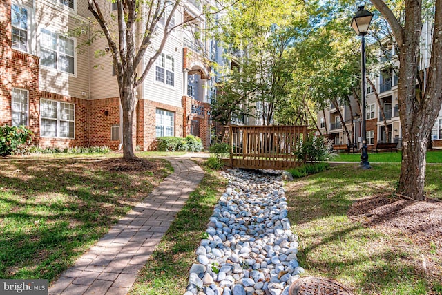 surrounding community featuring a deck and a yard