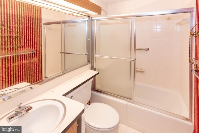 full bathroom featuring vanity, toilet, and combined bath / shower with glass door