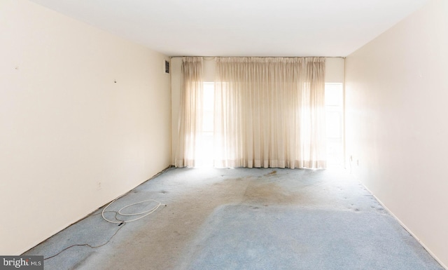 empty room with carpet flooring and visible vents