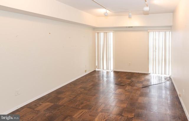 unfurnished room featuring baseboards