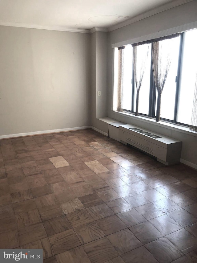 unfurnished room featuring baseboards and ornamental molding