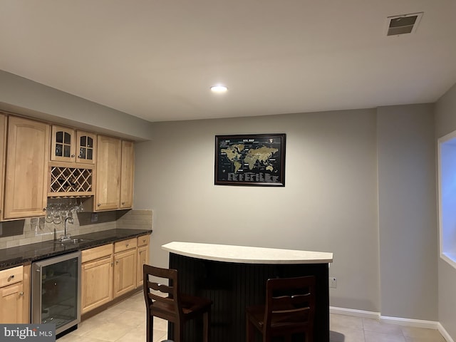 bar featuring indoor wet bar, wine cooler, visible vents, and backsplash