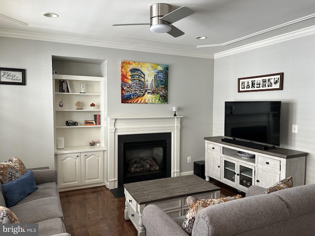 living room featuring a fireplace with flush hearth, dark wood-type flooring, ceiling fan, and crown molding