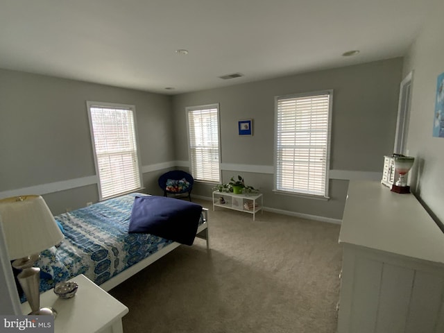 bedroom with carpet, visible vents, and baseboards