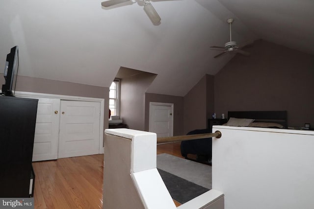 additional living space featuring light wood-style flooring, a ceiling fan, and vaulted ceiling