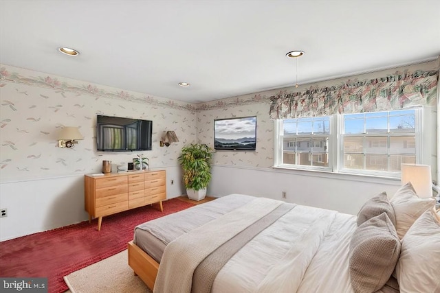 bedroom featuring wallpapered walls, a wainscoted wall, recessed lighting, and dark colored carpet