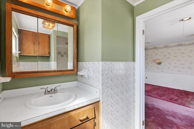 bathroom with a wainscoted wall and vanity