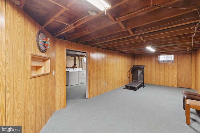 interior space with wooden walls, washer and dryer, and carpet