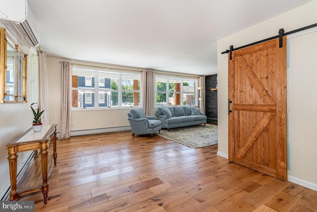 29 W Main St, Hershey, PA 17033 - living area featuring a wall mounted AC, a baseboard heating unit, light wood finished floors, baseboard heating, and a barn door