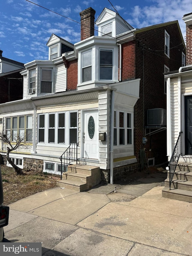 view of front of home featuring a chimney and entry steps