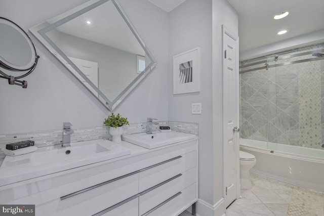 full bath featuring shower / bath combination with glass door, double vanity, a sink, toilet, and marble finish floor