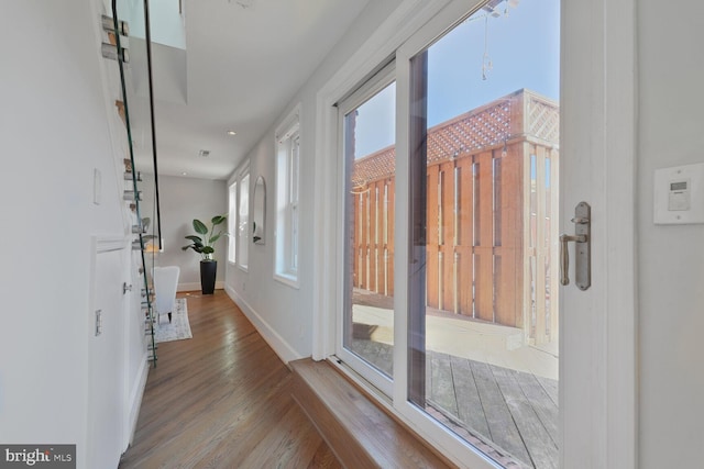 interior space with baseboards and wood finished floors