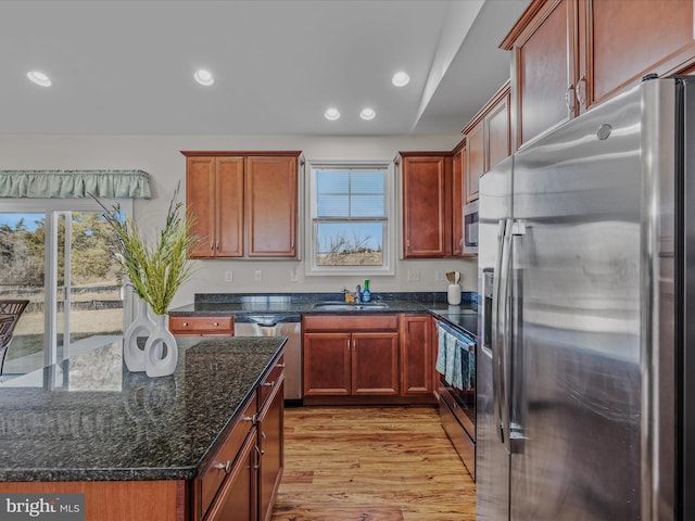 kitchen featuring recessed lighting, appliances with stainless steel finishes, light wood-style floors, and a sink