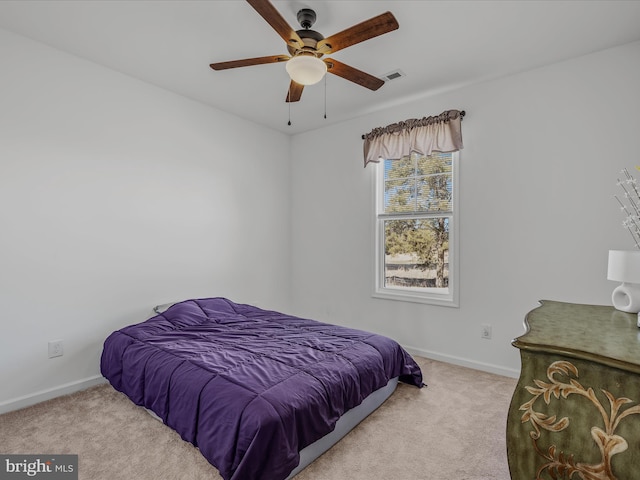 bedroom featuring visible vents, baseboards, carpet, and a ceiling fan