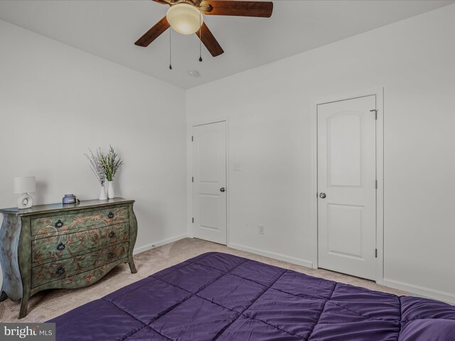 unfurnished bedroom featuring baseboards, carpet floors, and a ceiling fan