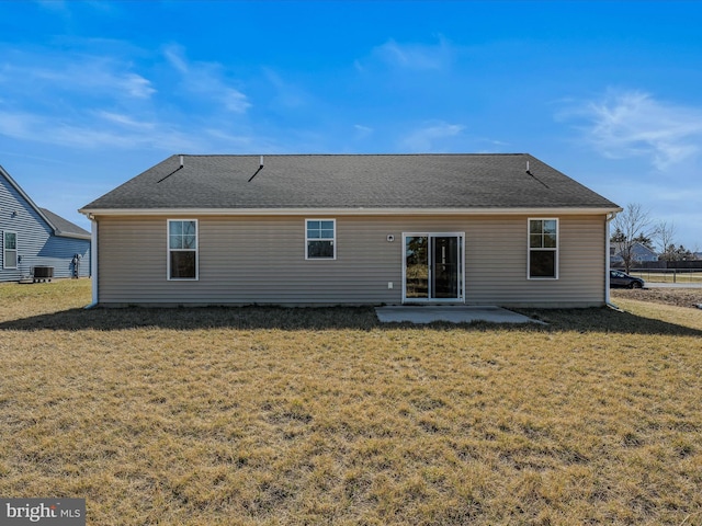 back of property featuring a patio area, central air condition unit, a lawn, and roof with shingles