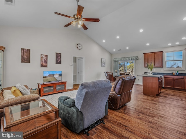 living room featuring baseboards, high vaulted ceiling, recessed lighting, dark wood-style flooring, and ceiling fan