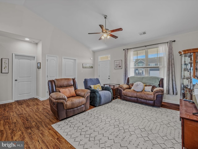 living area with visible vents, a ceiling fan, lofted ceiling, and wood finished floors