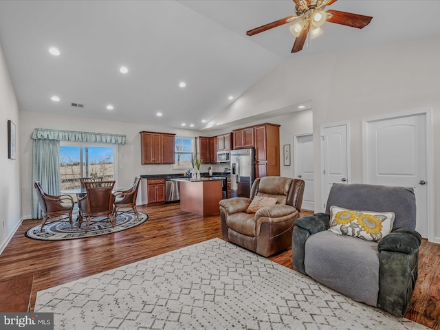 living area with wood finished floors, baseboards, visible vents, recessed lighting, and ceiling fan