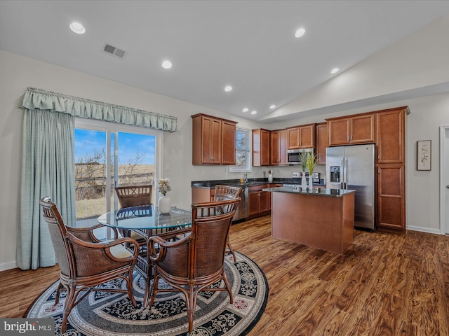 dining area with visible vents, dark wood-type flooring, recessed lighting, baseboards, and vaulted ceiling