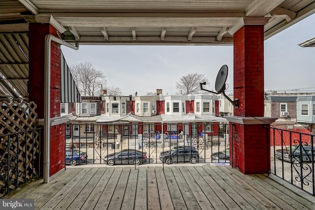 wooden terrace with a residential view