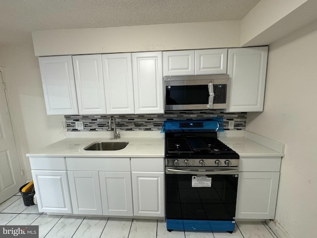 kitchen featuring a sink, stainless steel appliances, and white cabinets