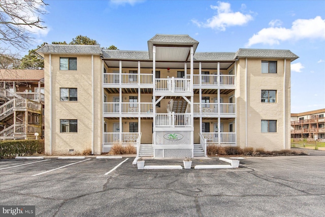 view of building exterior with uncovered parking