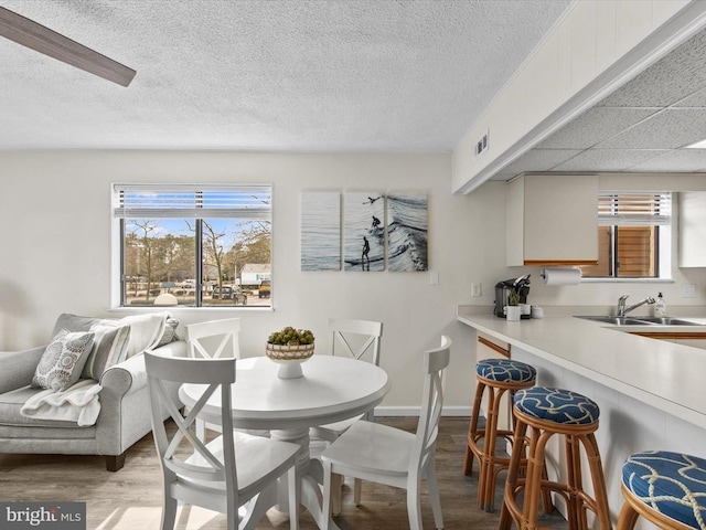 dining room with visible vents, baseboards, and wood finished floors