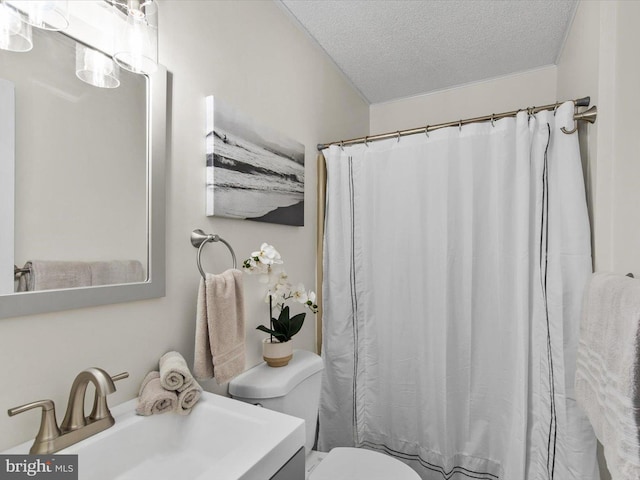 bathroom with a shower with shower curtain, toilet, vanity, and a textured ceiling