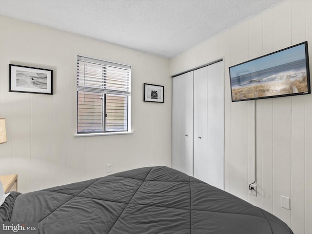 bedroom with a closet and a textured ceiling