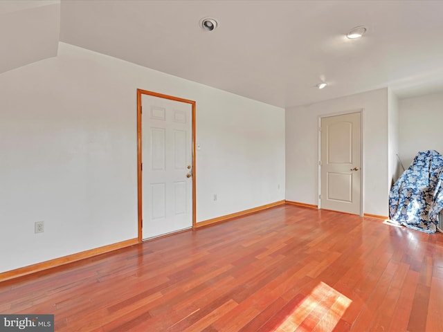 unfurnished room with light wood-type flooring and baseboards