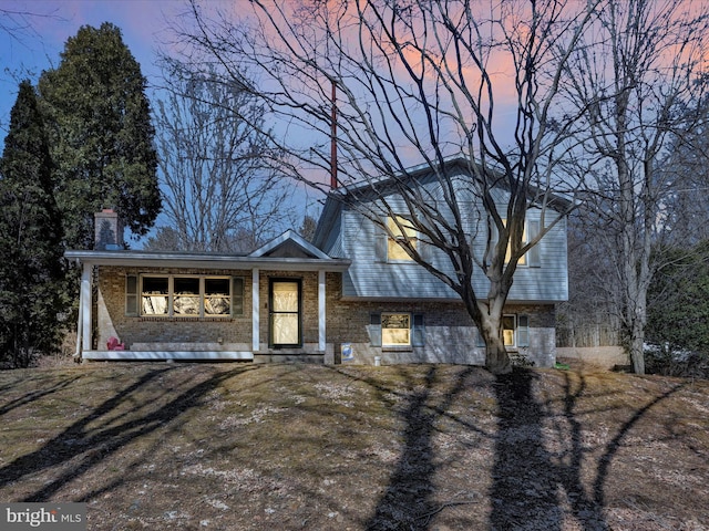 split level home featuring brick siding