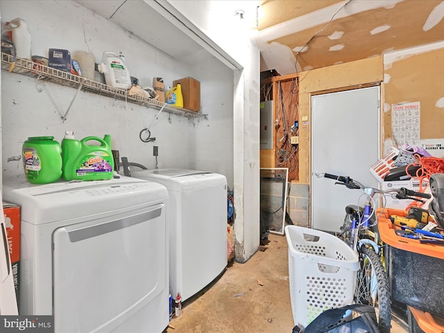 clothes washing area featuring laundry area, electric panel, and separate washer and dryer