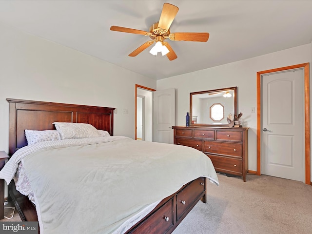 bedroom with light colored carpet and a ceiling fan