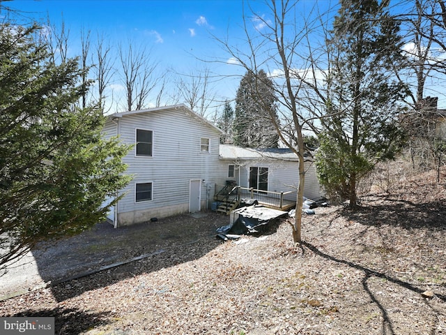 back of house featuring a wooden deck