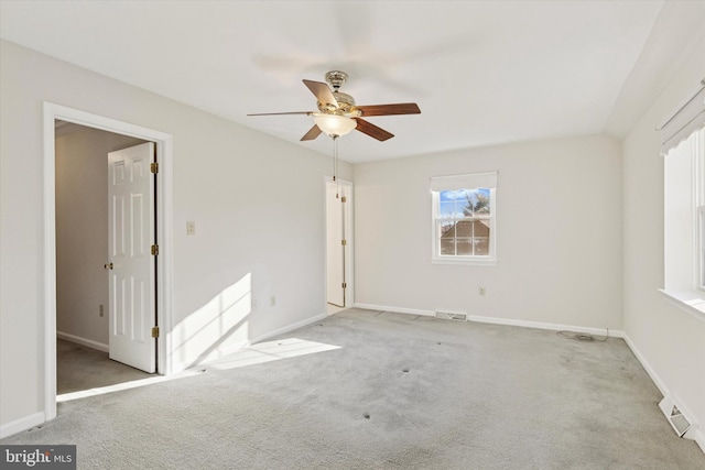 empty room featuring a ceiling fan, carpet flooring, baseboards, and visible vents