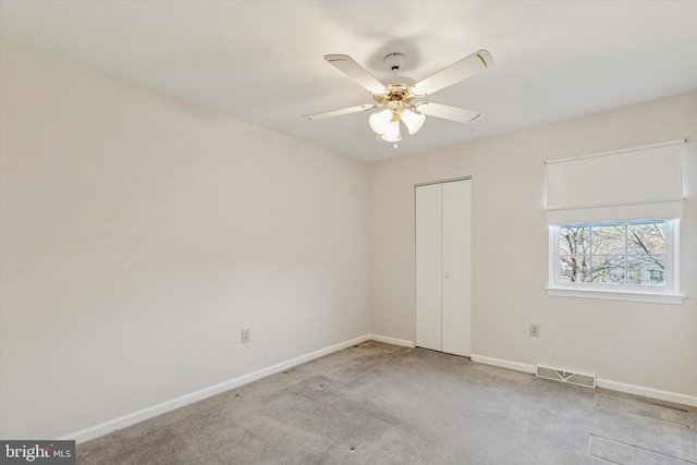 unfurnished bedroom featuring visible vents, baseboards, carpet floors, a closet, and a ceiling fan