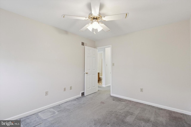 empty room featuring visible vents, baseboards, carpet, and ceiling fan