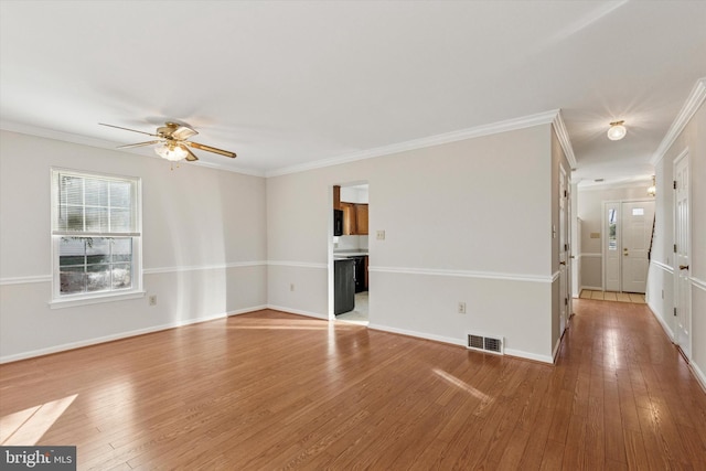 unfurnished living room with visible vents, baseboards, light wood-style floors, and crown molding